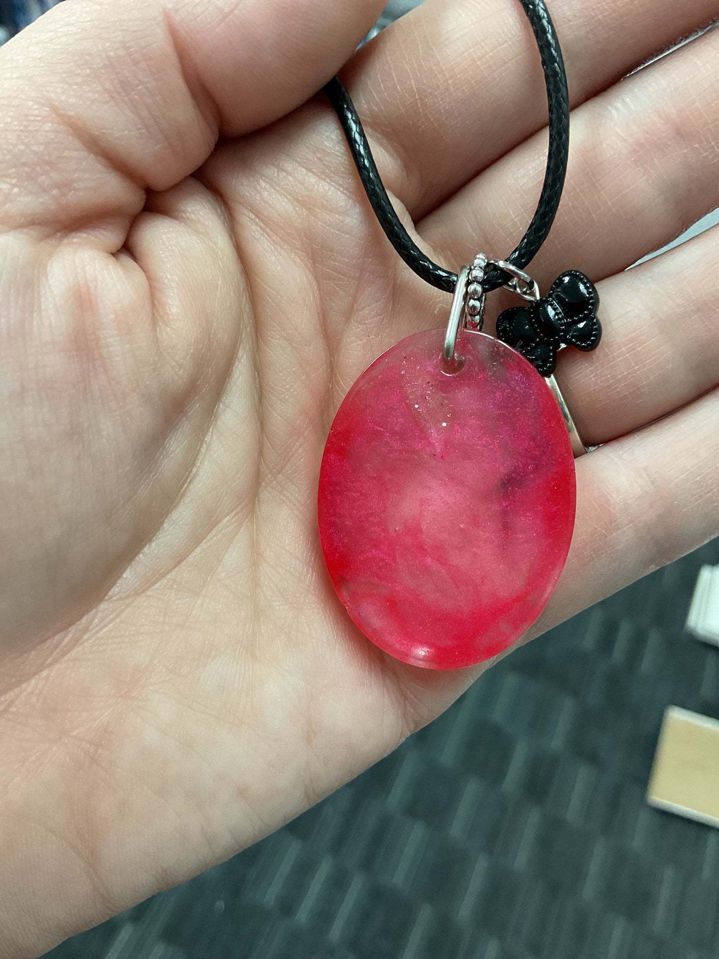 Red pigmented resin oval pendant