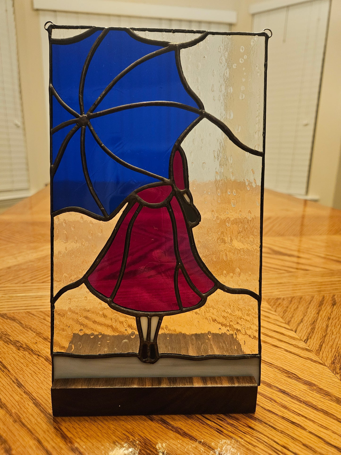 Girl in the rain with wood base