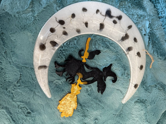 Witch hanging from moon