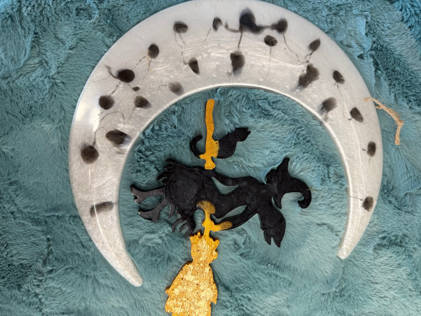 Witch hanging from moon