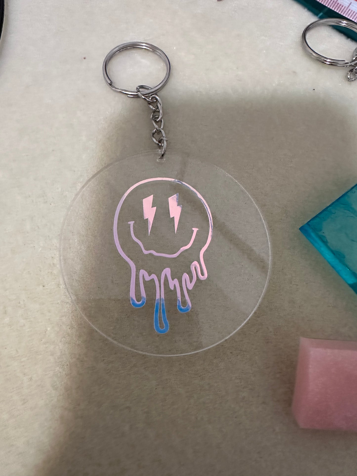 Acrylic keychain with vinyl drippy smiley face