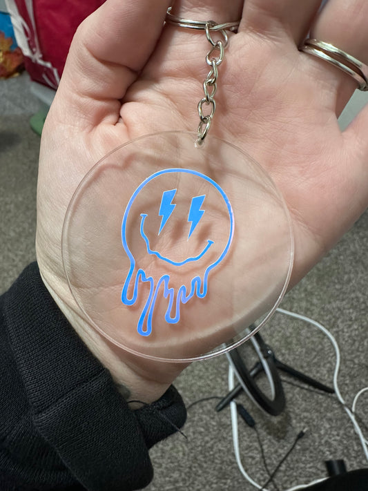 Acrylic keychain with vinyl drippy smiley face