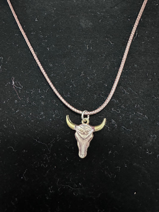 Brown and white steer-head pendant